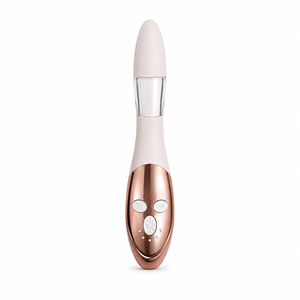 A sleek personal massager with a rose gold metallic body, a cream-colored upper section, and a clear neck, shown against a plain white background.