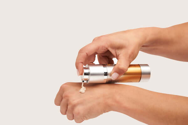 alastin c-radical defense antioxidant serum dispensing texture onto hand showing product consistency