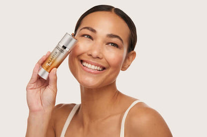 alastin c-radical defense antioxidant serum model holding product on face showing skincare application