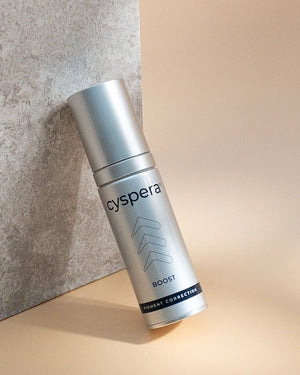 Cyspera Boost lifestyle bottle on neutral backdrop for pigment correction, radiance and smoother-looking uneven facial skin.