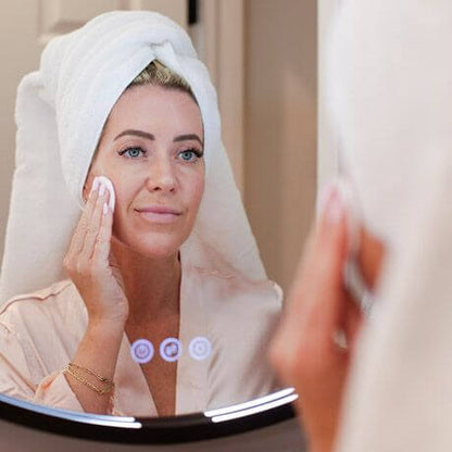 DefenAge 1-Step Multi Cleanse lifestyle image shows woman cleansing face with cotton pad for makeup removal and clean skin..