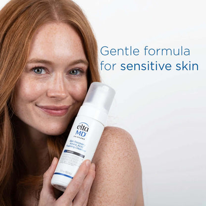 EltaMD Skin Recovery Amino Acid Foaming Cleanser lifestyle image shows model with bottle for gentle sensitive skin care use.