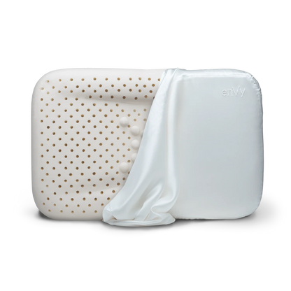 enVy anti-aging ergonomic pillow with natural latex core and copper-infused white silk pillowcase partially removed