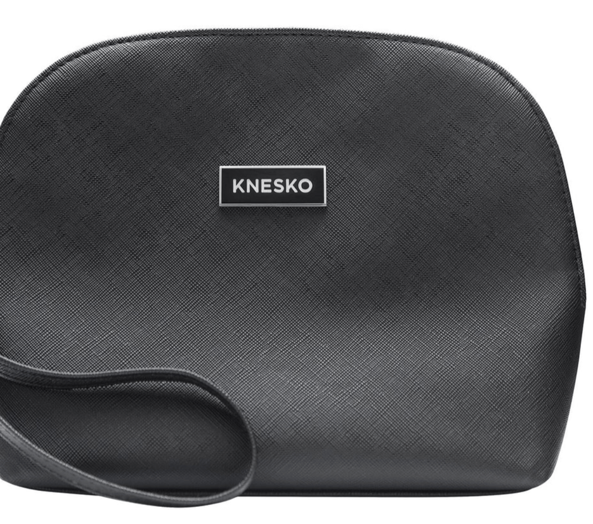Knesko black travel bag close up with textured finish and logo plaque for storing facial rollers and mask kits at home uses.