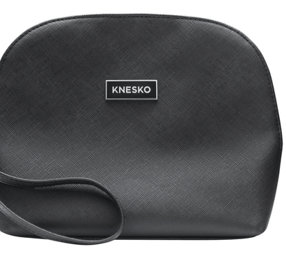 Knesko black travel bag close up with textured finish and logo plaque for storing facial rollers and mask kits at home uses.