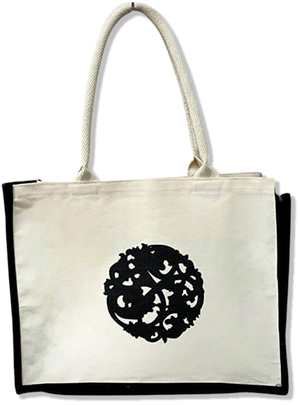 Nazarian Swag logo lined tote bag with cream canvas, black trim, and rope handles for everyday carrying.