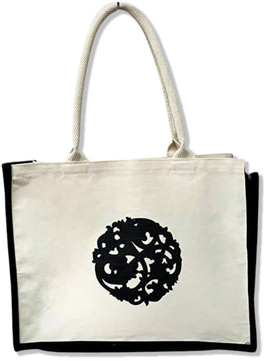 Nazarian Swag logo lined tote bag with cream canvas, black trim, and rope handles for everyday carrying.