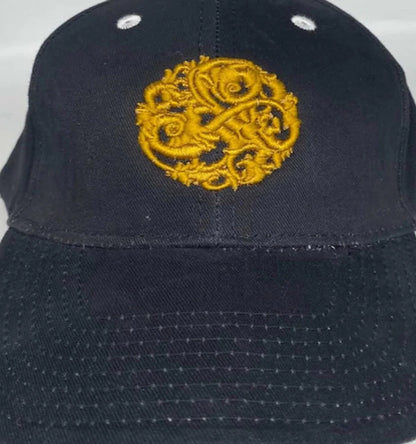 Close-up of NazarianSwag navy brushed cotton baseball cap showing gold embroidered logo and stitched brim details.
