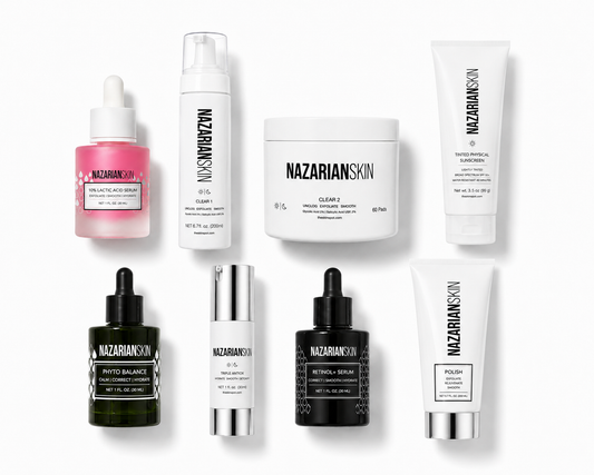 A collection of eight Nazarian Skin skincare products arranged in two rows on a clean white background. The products include a pink dropper bottle, a white pump bottle, a white jar, a white tube, a dark green dropper bottle, a white bottle with a silver cap, a black dropper bottle, and a white tube with a silver cap.

NazarianSkin Acne Regimen with glycolic acid, salicylic acid, retinol, sunscreen, polish, and moisturizer