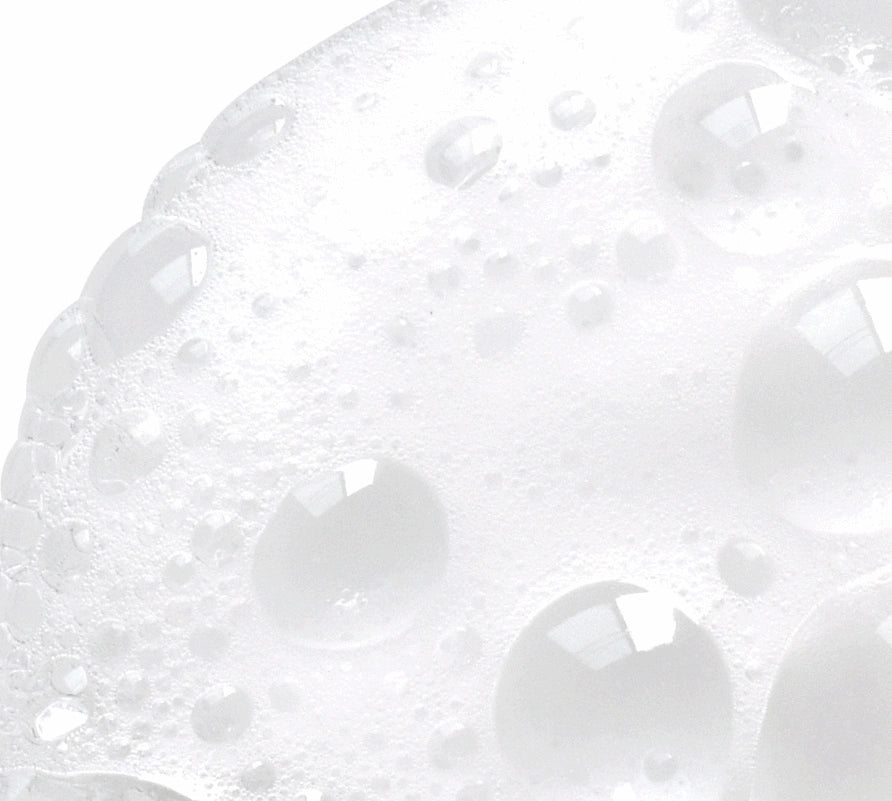 NazarianSkin Clear 1 foaming cleanser texture showing exfoliating bubbles with glycolic acid and salicylic acid.