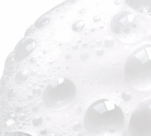 NazarianSkin Clear 1 foaming cleanser texture showing exfoliating bubbles with glycolic acid and salicylic acid.