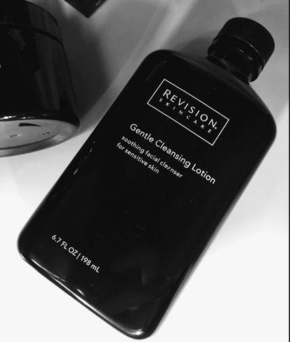 Revision Skincare Gentle Cleansing Lotion 6.7 oz bottle shown in lifestyle setting for soothing facial cleansing routine use