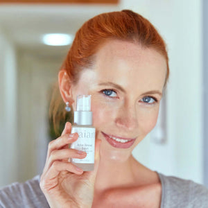 Saian Active Renewal Serum held near face highlights lightweight peptide serum for a smoother, hydrated-looking complexion.