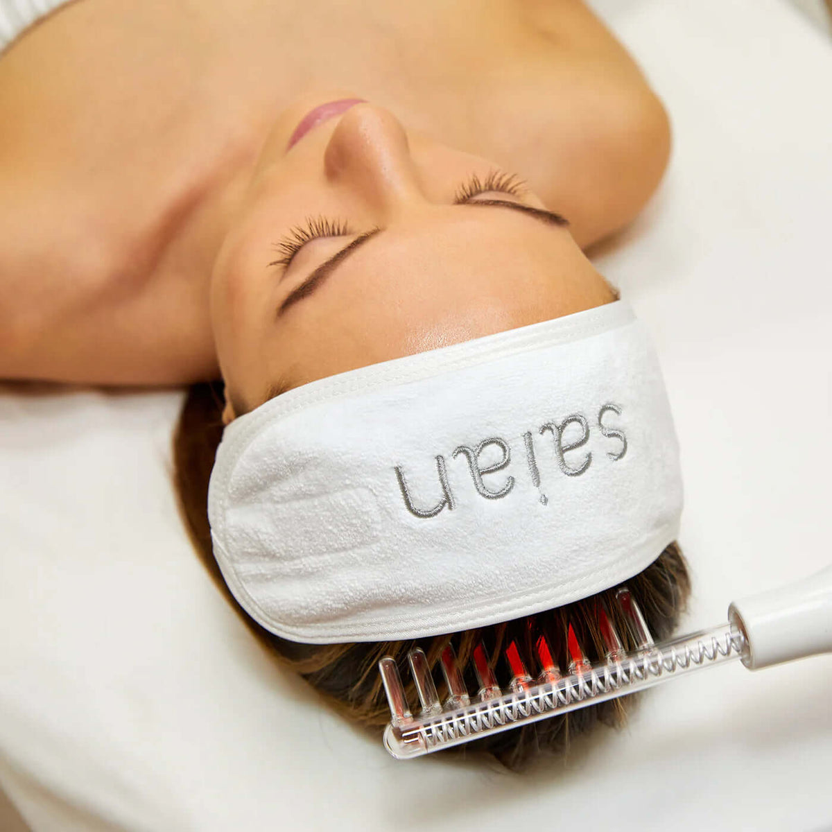 Saian High Frequency Facial Machine comb electrode used on scalp during spa hair and skin therapy treatment routine.