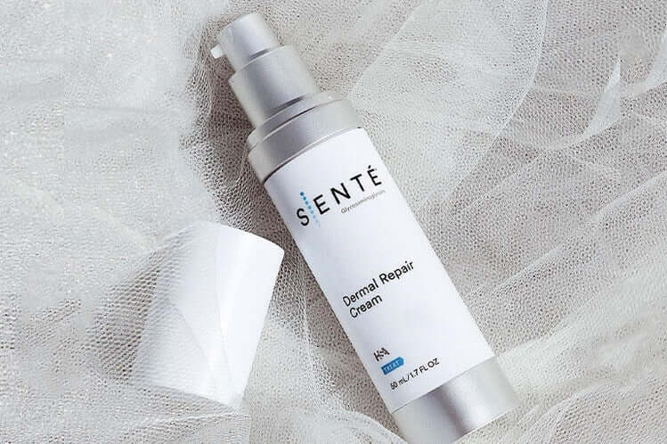 Senté Dermal Repair Cream bottle on soft white fabric for soothing sensitive skin and daily barrier repair care.