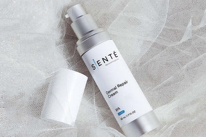Senté Dermal Repair Cream bottle on soft white fabric for soothing sensitive skin and daily barrier repair care.