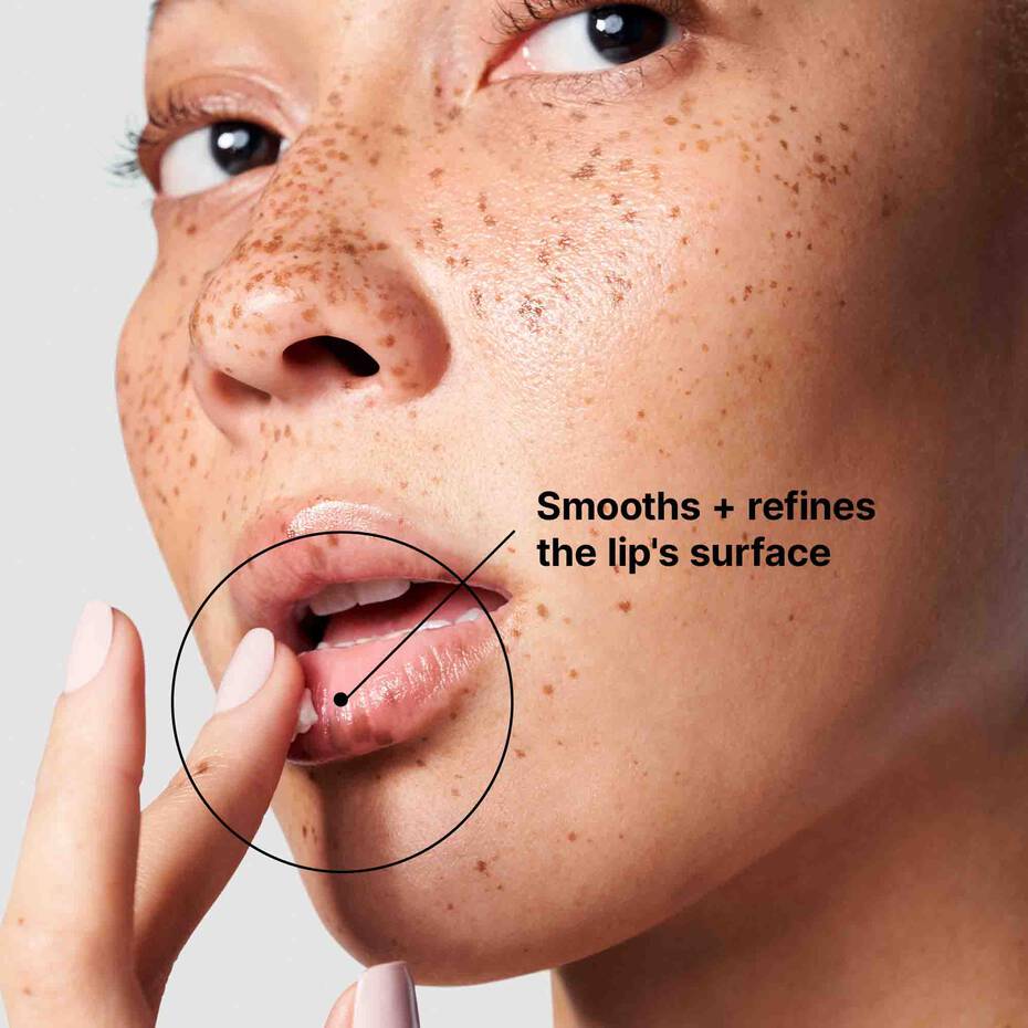 Model applying SkinCeuticals Antioxidant Lip Repair to refine lip surface and smooth dry texture on close-up face