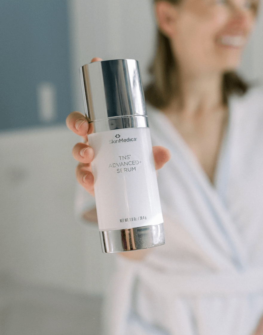 SkinMedica TNS Advanced+ Serum held in hand for daily anti-aging skincare, smoother texture, and firmer-looking skin at home