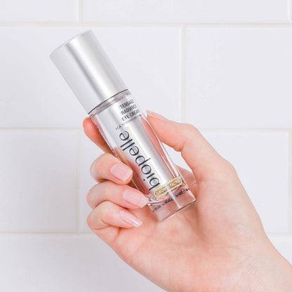 Tensage Radiance Eye Cream held in hand with SCA Biorepair and peptides for dark circles, puffiness and brighter under eyes.