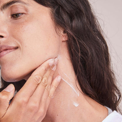 Applying Alastin Restorative Neck Complex to neck area showing neck firming cream for smoother and tighter skin