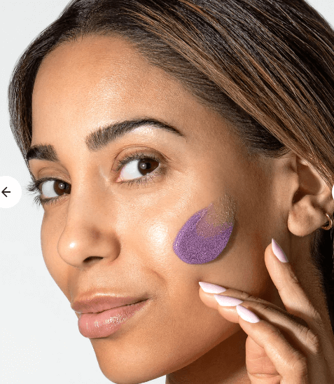 Woman applying Alastin ReSurface Skin Polish exfoliating face polish by Alastin Skincare for smooth glowing skin