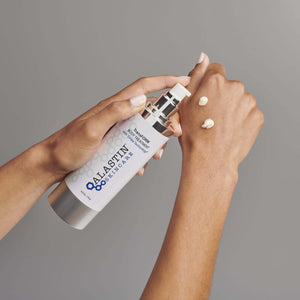 Alastin TransFORM Body Treatment applied on hand showing firming lotion texture and smooth skin after daily use routine