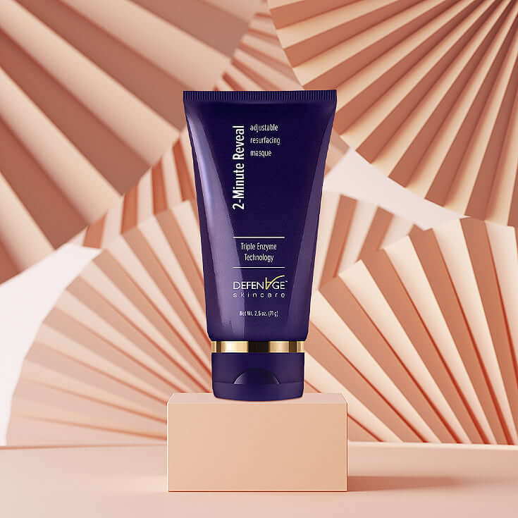 DefenAge 2 Minute Reveal Masque tube on peach display for Triple Enzyme resurfacing, exfoliating and brighter skin care use.