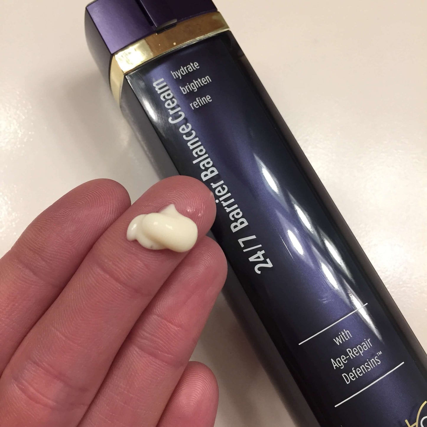 DefenAge 24/7 Barrier Balance Cream Fragrance Free cream texture on fingertip shows Age-Repair Defensins for smooth skin use