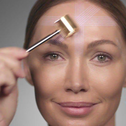 Environ Gold Roll-CIT how-to-use — woman applying gold microneedle roller to forehead zone sections for even skin coverage