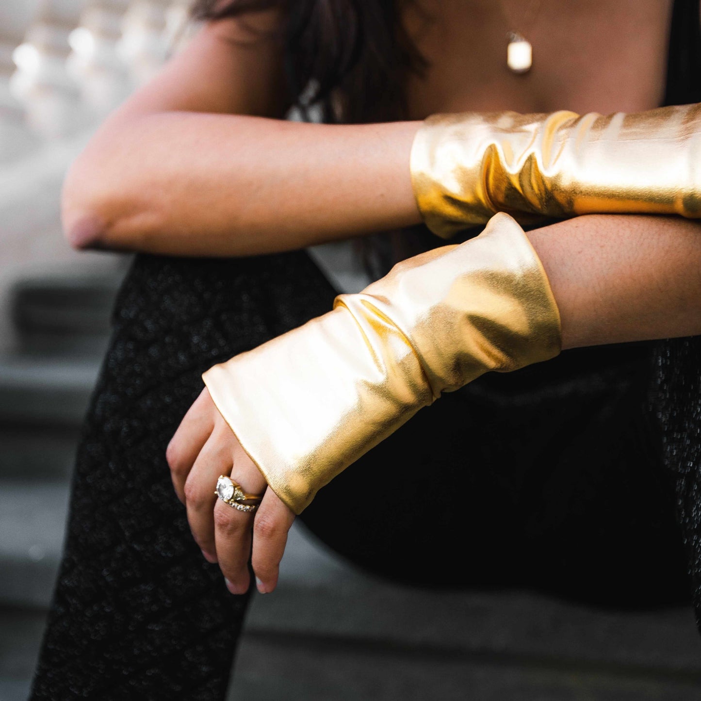 Woman wearing gold hand love gloves SPF50 UV protection gloves to prevent sun damage aging spots and protect hands daily