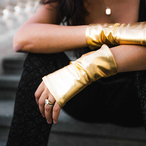 Woman wearing gold hand love gloves SPF50 UV protection gloves to prevent sun damage aging spots and protect hands daily