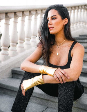 Woman wearing gold hand love gloves SPF50 UV protection gloves protecting hands from sun damage aging spots outdoor use