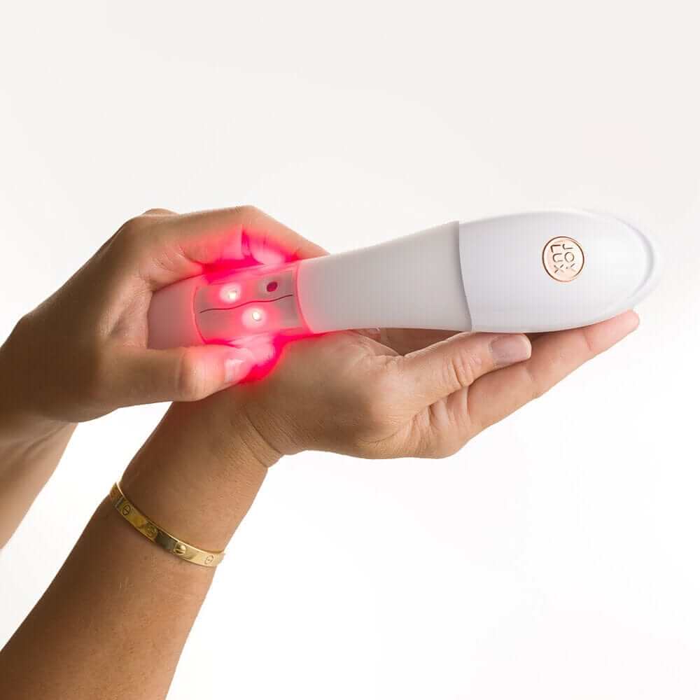 Joylux vFit Gold PLUS device with USB charging cable and travel sachet — complete feminine rejuvenation kit for at-home use