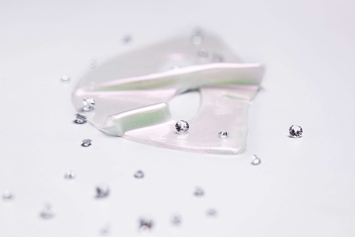 Knesko Diamond Radiance Face Mask hydrogel pieces with diamond accents showing brightening luxury collagen mask texture glow