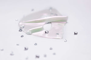 Knesko Diamond Radiance Face Mask hydrogel pieces with diamond accents showing brightening luxury collagen mask texture glow