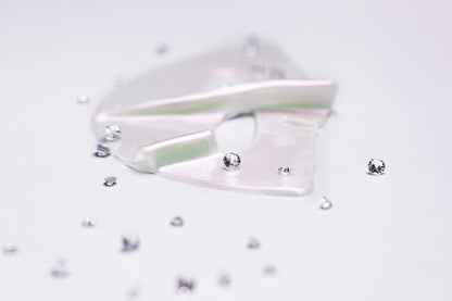 Knesko Diamond Radiance Face Mask hydrogel pieces with diamond accents showing brightening luxury collagen mask texture glow