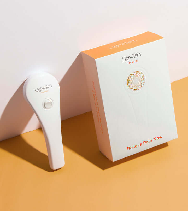 LightStim for Pain device with product box featuring red light therapy for temporary pain relief and daily recovery at home.