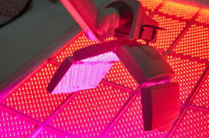 LightStim LED Bed and ProPanel red light therapy device with bright facial panels over glowing LED bed in treatment room use