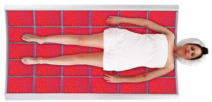 LightStim LED Bed and ProPanel overhead view showing full body red light therapy treatment on glowing LED panels for spa use
