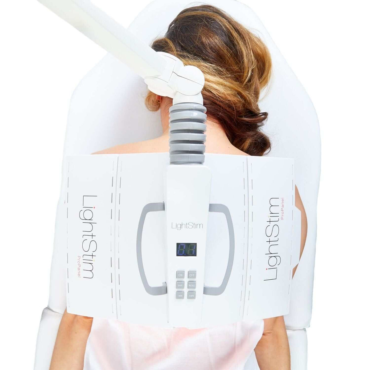 LightStim ProPanel Anti-Aging Light positioned over back for red LED therapy treatment in spa treatment chair setup care now