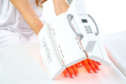 LightStim ProPanel Anti-Aging Light treating hands with red LED therapy to support smoother brighter looking skin glow care.