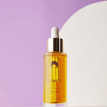 Lumity facial oil bottle on lavender background, anti-aging skin nutrients oil for dry dull skin and healthy glow daily uses