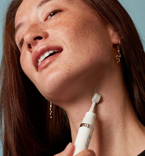 Model applying MesoLyft Neck roller with marine algae formula for aging neck skin, texture, and décolletage support use now.