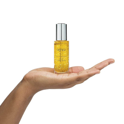 Obagi Daily Hydro-Drops bottle resting on hand shows hydrating serum for dry skin, fine lines, and radiant texture care use.