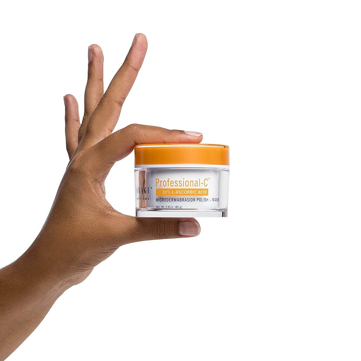Hand holding Obagi Professional-C Microdermabrasion Polish + Mask jar for 30% vitamin C exfoliation and radiant skin glow...