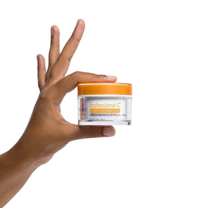 Hand holding Obagi Professional-C Microdermabrasion Polish + Mask jar for 30% vitamin C exfoliation and radiant skin glow...