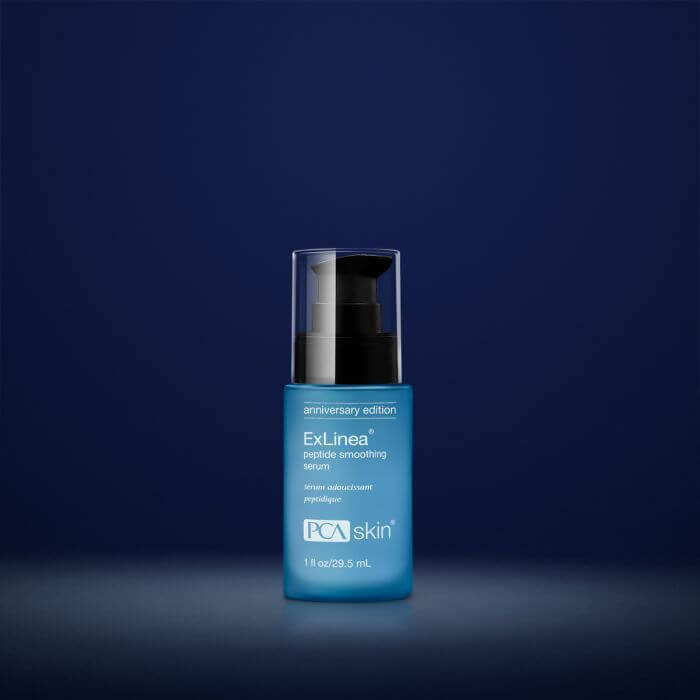 PCA Skin ExLinea Peptide Smoothing Serum blue bottle on navy backdrop for peptide smoothing and firming wrinkle care use now