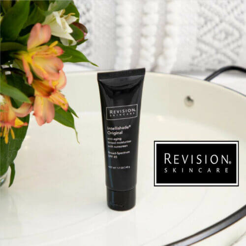 Revision Skincare Intellishade Original SPF 45 tinted moisturizer tube displayed on vanity for daily sunscreen use