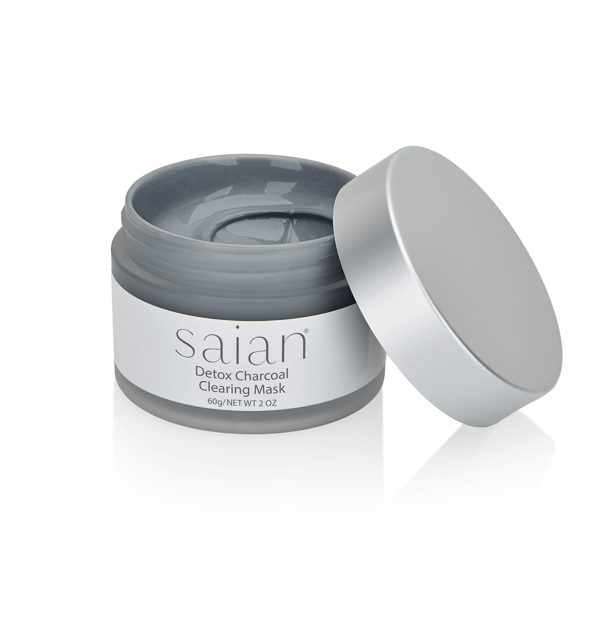 Saian Detox Charcoal Clearing Mask open jar shows smooth gray charcoal mask texture with silver lid beside the product.