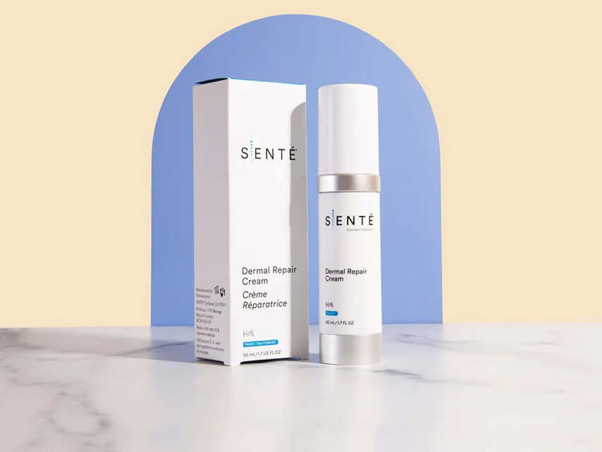 Senté Dermal Repair Cream bottle with packaging on pastel background for redness relief and skin comfort care.